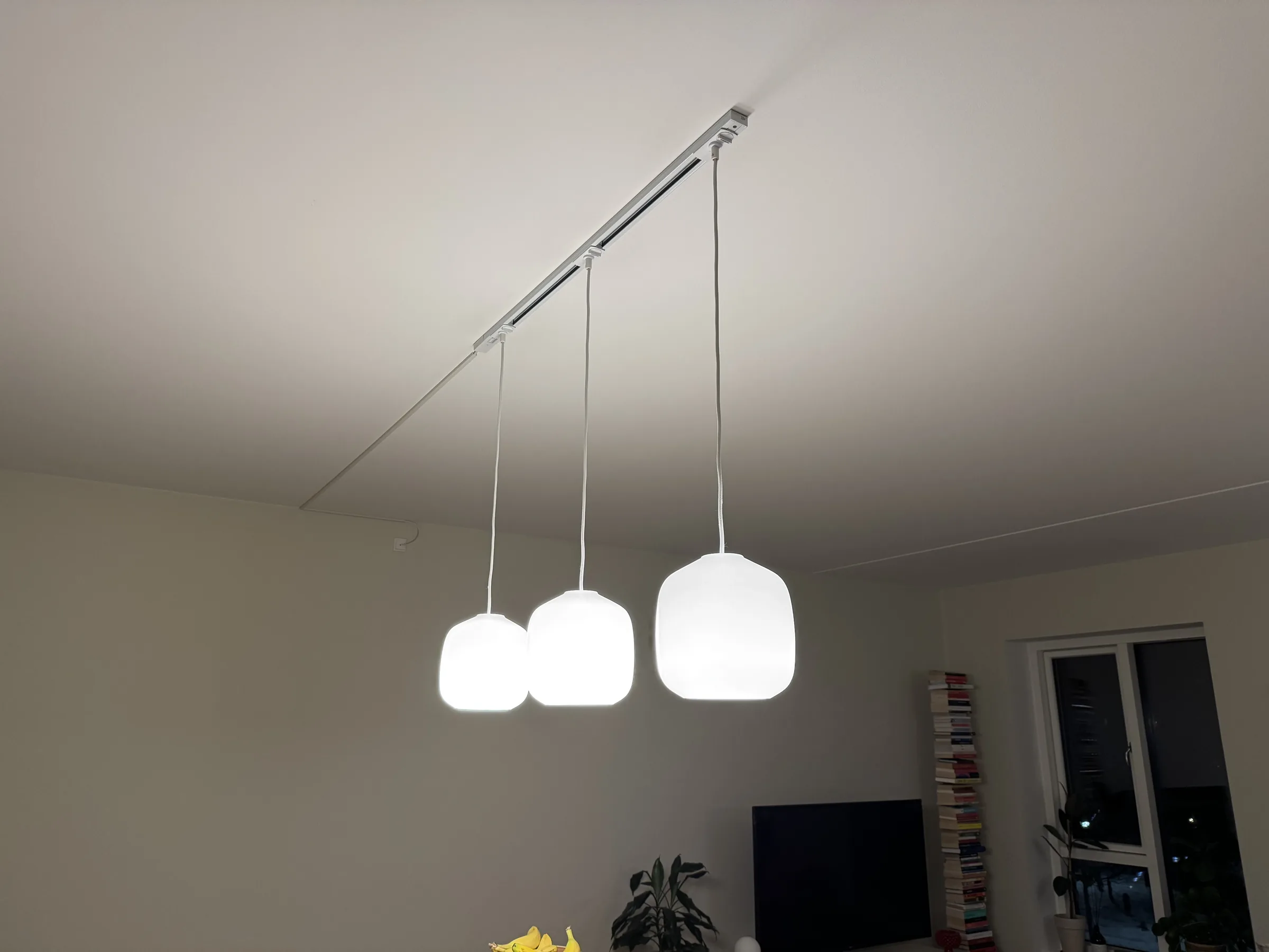 Finished ceiling lamp hanging neatly above the kitchen area in a Copenhagen apartment
