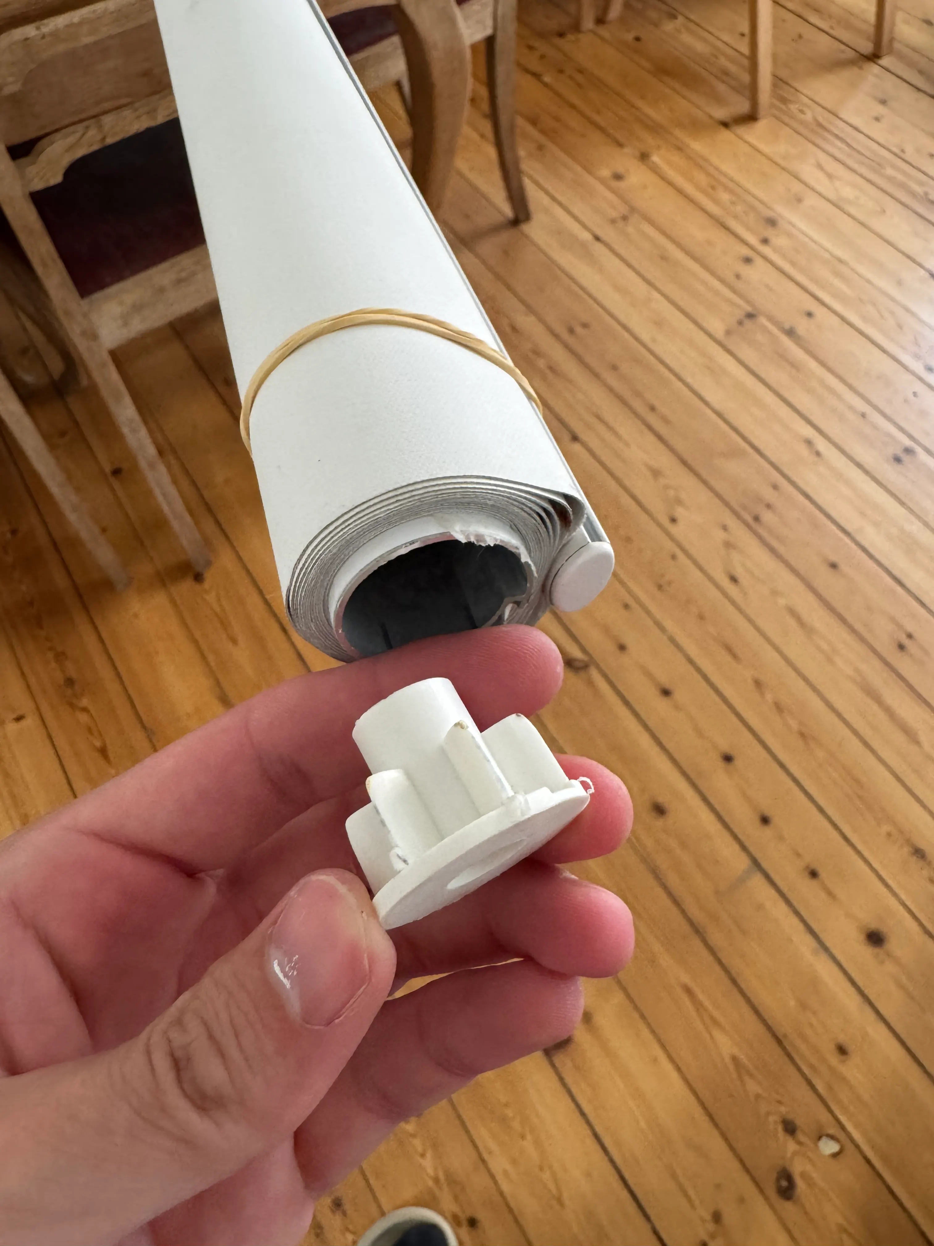 Existing roller blind tube and original damaged control component before repair