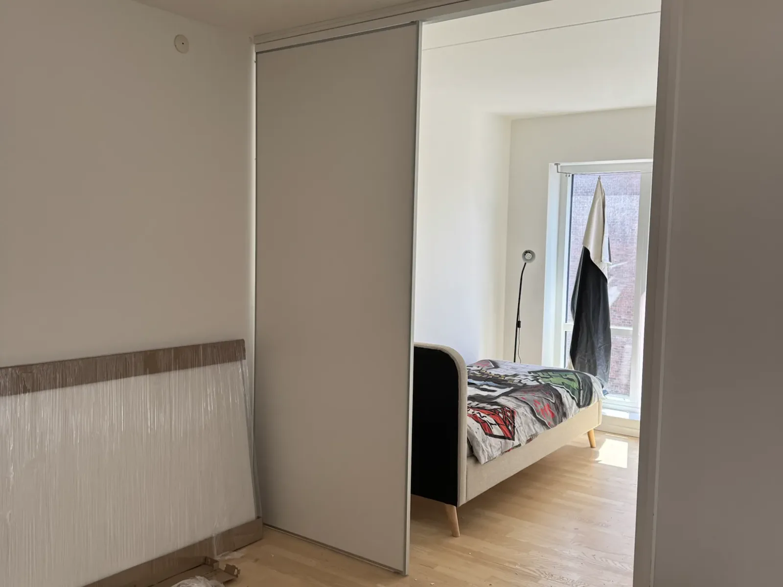 Sliding door panel fitted into the ceiling track during installation