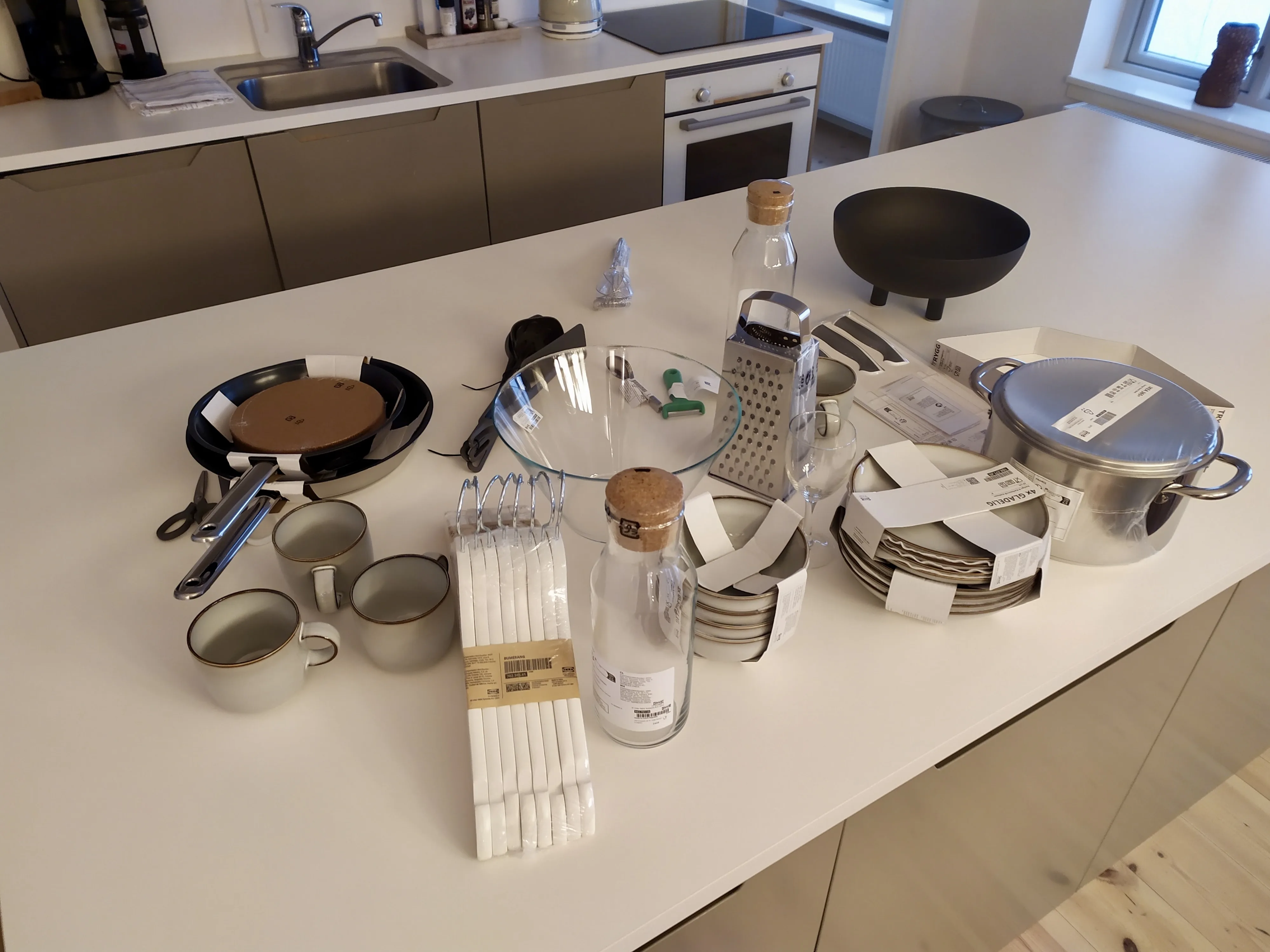 Kitchen inventory arranged for a readiness check in a furnished rental apartment