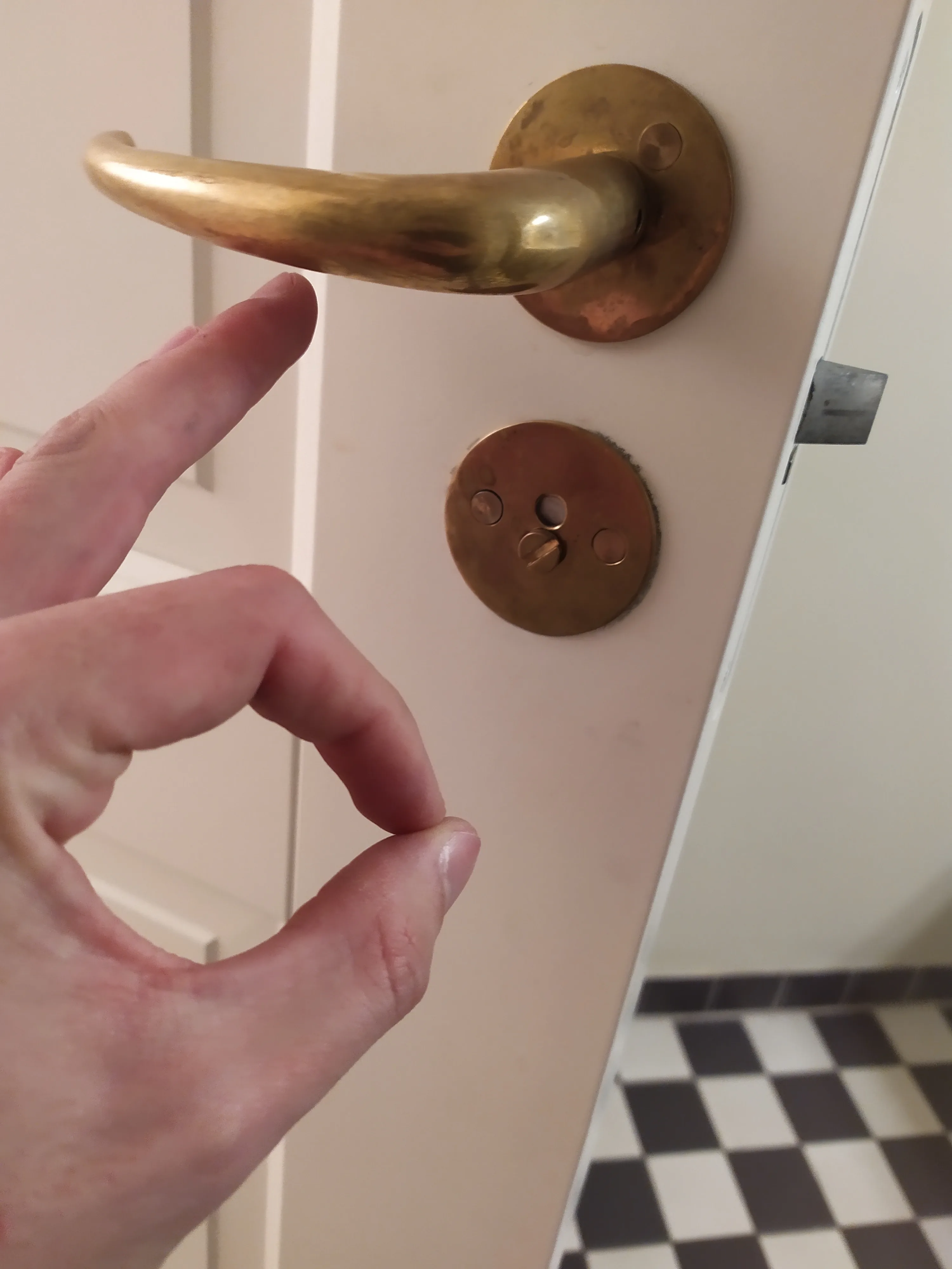 Door lock hardware checked during rental apartment maintenance